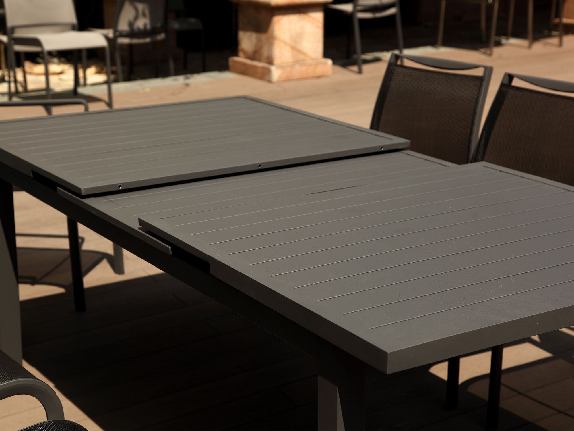 Bell Outdoor Extendable Dining Table - Modo Furniture in The hidden mechanics of butterfly leaves and mortise tenon joinery ensuring summer gatherings stay stable