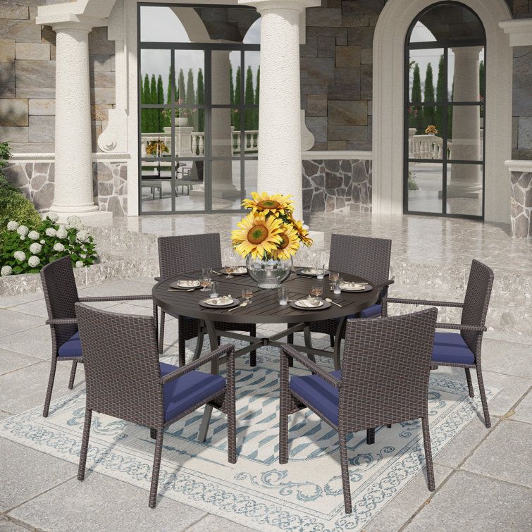 Wildon Home® Sutiya 6 - Person Round Outdoor Dining Set With Cushions ... with Swivel chairs and slatted designs finding the perfect blend of comfort and airflow for summer meals